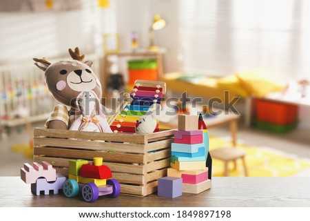 Set of different cute toys on wooden table in children's room Сток-фото © 