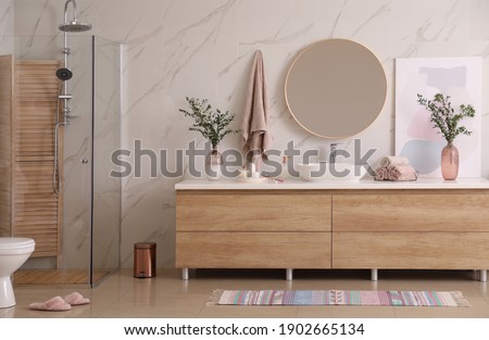 Modern bathroom interior with stylish mirror and vessel sink