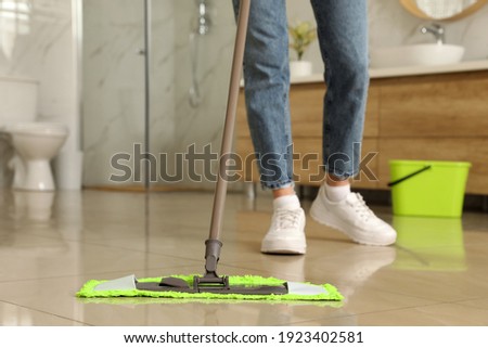 Woman cleaning floor with mop at home, closeup Stock fotó © 
