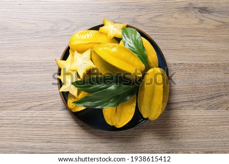 Delicious carambola fruits on wooden table, top view Сток-фото © 