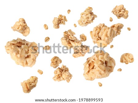 Delicious granola falling on white background. Healthy snack  