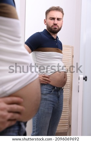 Similar – Image, Stock Photo Overweight male with mirror applying red lipstick