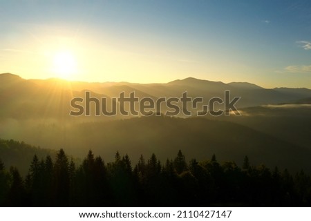 Similar – Foto Bild Sonne scheint am nebligen Morgen über den Bergen