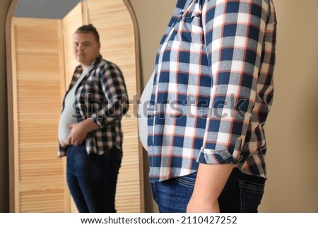 Similar – Image, Stock Photo Overweight male with mirror applying red lipstick