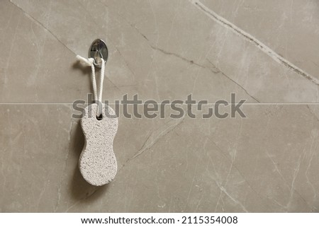 Pumice stone hanging on grey wall, space for text ストックフォト © 