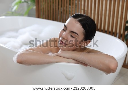 Similar – Image, Stock Photo Young woman in bathtub with balloons after party