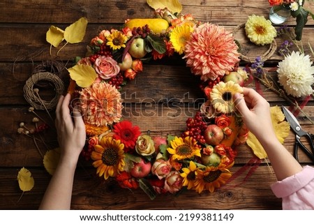 Similar – Image, Stock Photo Beautiful autumn wreath or circle frame made with pretty fall leaves, chestnuts, nuts, acorns and flowers on white background. Top view. Flat lay. Creative layout