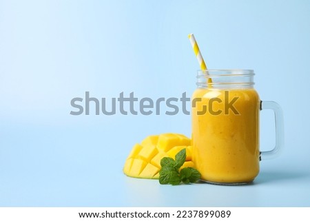 Similar – Foto Bild Mango-Smoothie auf blauer Farbe. Sommerliches Getränk. Mangoshake mit Strohhalm