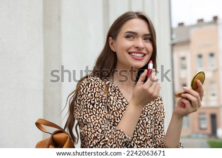 Similar – Image, Stock Photo Woman applying lipstick and looking in side mirror of bus