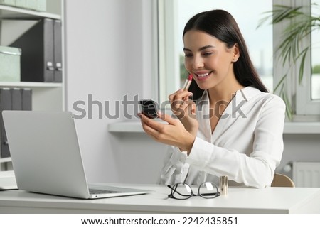 Similar – Image, Stock Photo A young woman makes a snow angel lying in the snow with her arms and legs spread to the sides