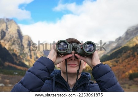 Similar – Image, Stock Photo teenager looks through a magnifying glass and pulls up her nostrils