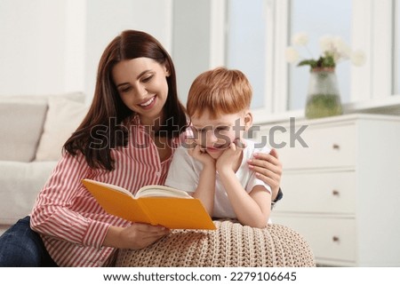 Similar – Image, Stock Photo Mother reading book her daughter in bed before going to sleep. Bedtime stories for child