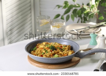 Similar – Image, Stock Photo Pan with rice and beans decorated with chopped green chilies and served on a wooden table