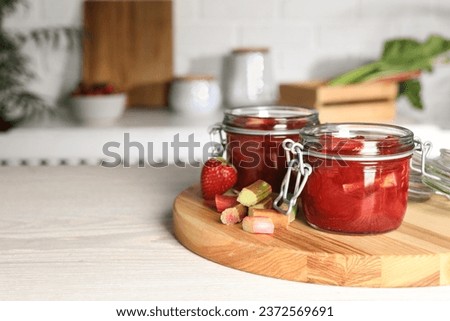 Similar – Image, Stock Photo Fresh strawberries and rhubarb on wooden table background with ingredients for tasty seasonal cooking or baking. Top view. Healthy clean food. Paleo dieting. Home cuisine. Garden fruits eating