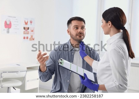 Similar – Image, Stock Photo Male doctor examining patient in medical room