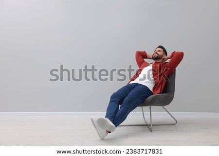 Similar – Image, Stock Photo Stylish young man sitting on concrete wall