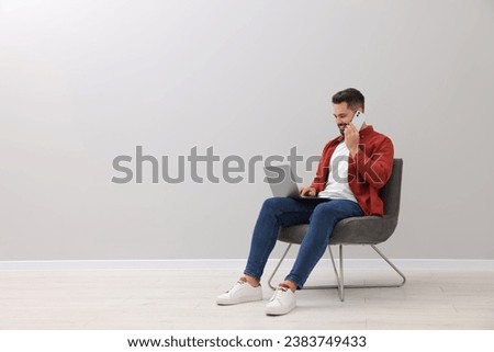 Similar – Image, Stock Photo Man talking on smartphone while browsing laptop