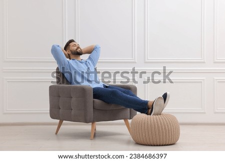 Similar – Image, Stock Photo Stylish young man sitting on concrete wall