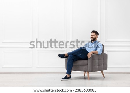 Similar – Image, Stock Photo Stylish young man sitting on concrete wall