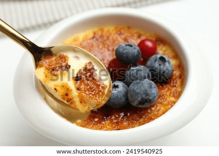 Similar – Image, Stock Photo Creme brulee with caramel crust. Burning sugar on burnt cream