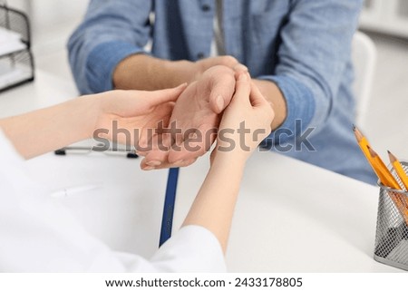 Similar – Image, Stock Photo Male doctor examining patient in medical room