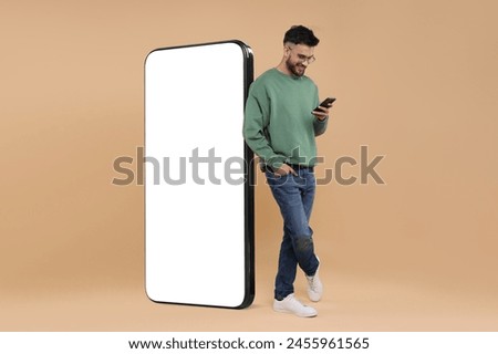 Similar – Image, Stock Photo Young man with mobile phone in the autumn park