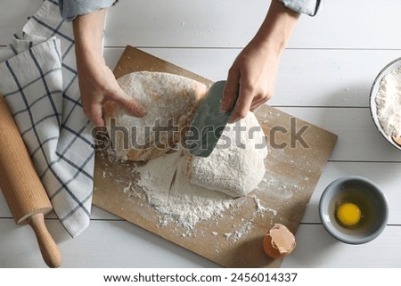 Similar – Image, Stock Photo Cook cutting dough with knife in shape on table