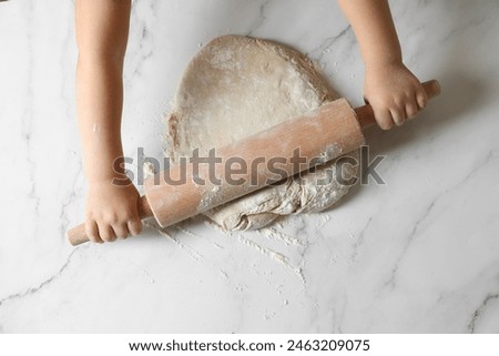 Similar – Image, Stock Photo Baker rolling out dough in kitchen