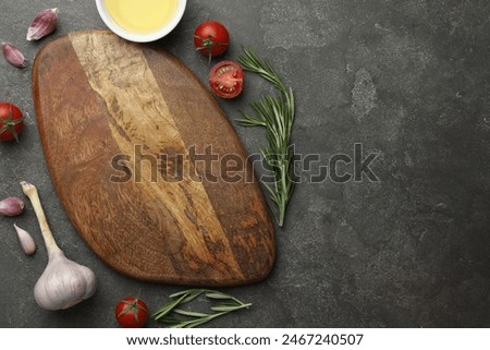 Similar – Image, Stock Photo Food background with empty wooden cutting board, herbs, garlic, olive oil, spices on grey concrete kitchen table. Cooking with fresh, flavorful ingredients. Top view with copy space.