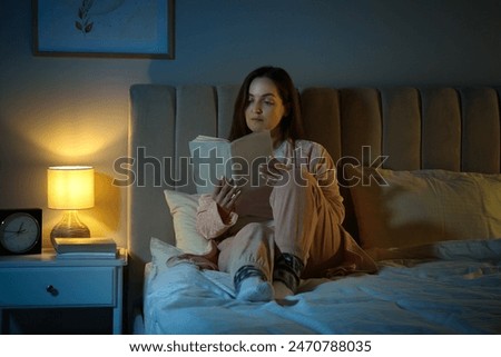 Similar – Image, Stock Photo Woman reading a book in cafe sitting at wooden table with flowers in a vase. Romantic date with a book. Brown vintage neutral color background. Literature & Library, book lover spending leisure time.