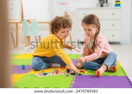 Similar – Image, Stock Photo Children playing with fishing rod toy in a pool in a home garden
