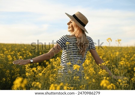 Similar – Image, Stock Photo Smiling woman in blooming field