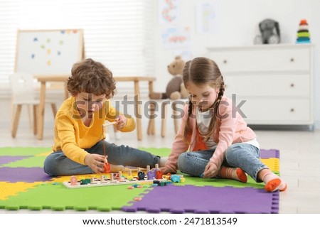 Similar – Image, Stock Photo Toddler playing with a colorful plastic bug toy; using hands to manipulate small object developmental milestone