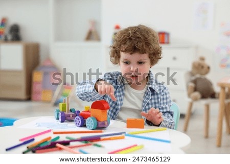 Similar – Image, Stock Photo Toddler playing with toy