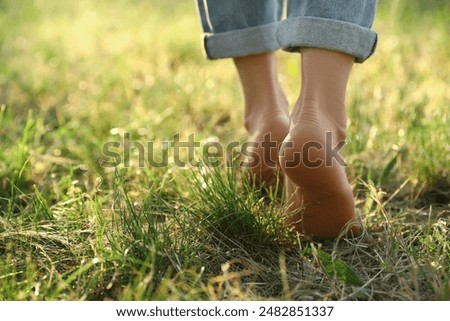 Image, Stock Photo Young female walking barefoot on wet sand