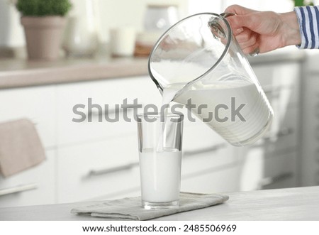 Similar – Image, Stock Photo Woman pouring fresh milk from bottle to enamel mug while having refreshment in garden