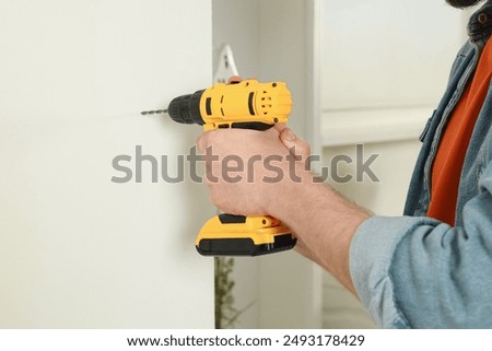 Similar – Image, Stock Photo Man worker drilling wall with hammer drill, top view