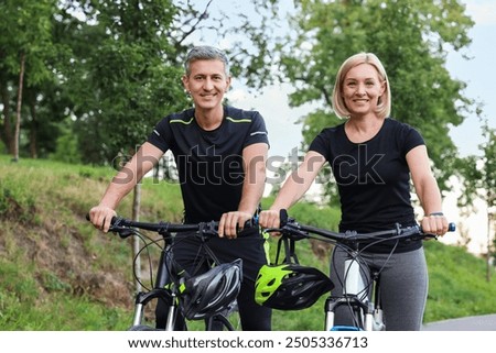 Similar – Image, Stock Photo Active sporty couple riding mountain bikes on demanding forest trail.