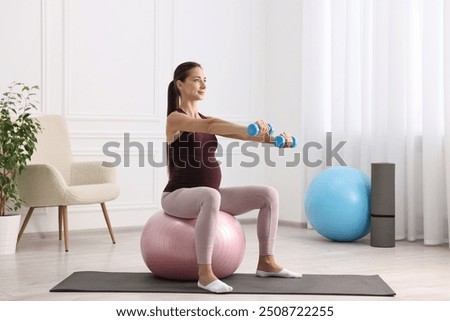 Image, Stock Photo Pregnant woman exercising with personal trainer