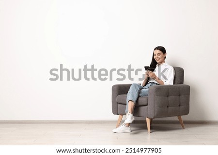 Similar – Image, Stock Photo Smiling woman sitting on bench in park with closed eyes on sunny day