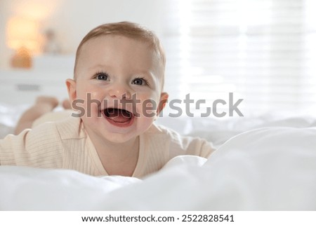 Cute little baby on bed at home