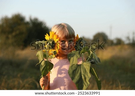 Similar – Foto Bild chica sujetando girasoles en el balcon