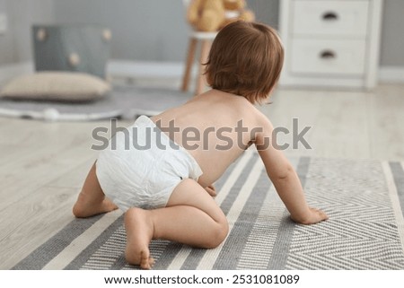 Similar – Image, Stock Photo Adorable little baby boy in feeding chair being spoon fed by his mother