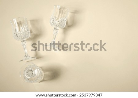 Similar – Image, Stock Photo empty wine glasses. Beautiful new glasses for wine from glass stand in even rows on a wooden table in a restaurant. selective focus