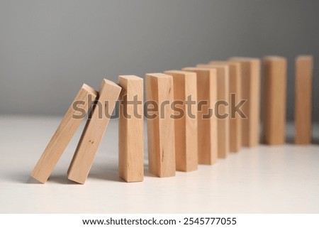 Similar – Image, Stock Photo The wooden domino blocks falling down