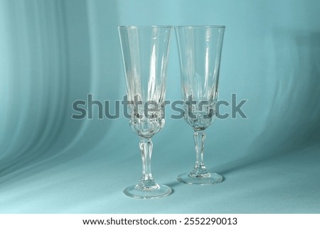 Similar – Image, Stock Photo empty wine glasses. Beautiful new glasses for wine from glass stand in even rows on a wooden table in a restaurant. selective focus