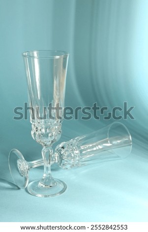 Similar – Image, Stock Photo empty wine glasses. Beautiful new glasses for wine from glass stand in even rows on a wooden table in a restaurant. selective focus