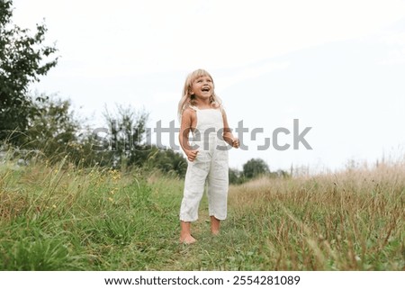 Similar – Image, Stock Photo Little girls walking barefoot on the sand and caring a picnic basket together. Summer leisure, love and friendship.