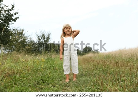 Similar – Image, Stock Photo Little girls walking barefoot on the sand and caring a picnic basket together. Summer leisure, love and friendship.