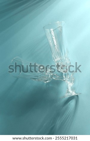 Similar – Image, Stock Photo empty wine glasses. Beautiful new glasses for wine from glass stand in even rows on a wooden table in a restaurant. selective focus